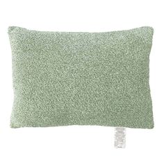 a green pillow with a tag on the front and side of it that says, i love