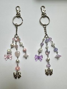 two key chains with charms attached to them