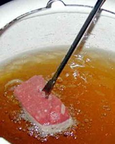 a pink mop is in the middle of a dirty bowl with water on it