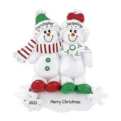 two snowmen are standing next to each other