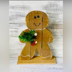 a wooden cutout of a ginger holding a potted plant