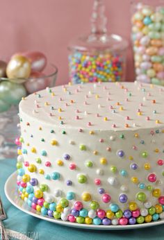 a white cake with multi colored sprinkles on it's icing