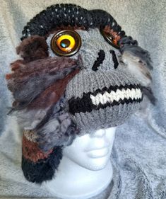 Each Bigfoot/Sasquatch hat is handmade--the combination of colors and yarn type, along with eye variations and expressions ensure that no two are exactly alike.  ITEM PICTURED IS WHAT YOU WILL RECEIVE (size in title).  Hats are warm and soft, with earflaps; each is individually named, using different world-wide terms for the Sasquatch. Sizes are suitable for adults and older children (smaller sizes can be requested).  As they are knit and do stretch, the average size fits most.  Hats come prewashed so there is no fear of shrinking.  Nearly all yarn is acrylic, but some have a small percentage of wool or other natural fiber. I have been interested in Sasquatch (the name I prefer) since childhood.  I believe that there are undiscovered species in this world, small and large, that have manage Handmade Funky Hats One Size Fits Most, Unique Handmade Hat One Size, Unique Handmade One-size Hats, Handmade Beanie Costume Hats One Size, Handmade Halloween Beanie Hat, Quirky Handmade Winter Hats, Handmade Halloween Beanie, Handmade Gray Hat One Size, Handmade Gray Hats One Size