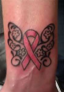 a pink ribbon tattoo on the foot of a woman