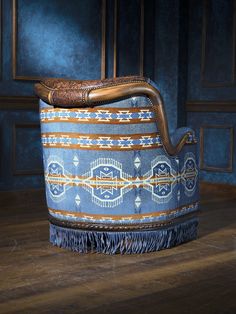 a blue and brown chair sitting on top of a wooden floor