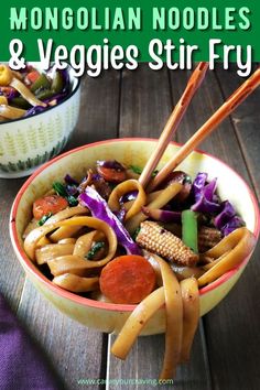 two bowls filled with stir fry vegetables on top of a wooden table next to chopsticks