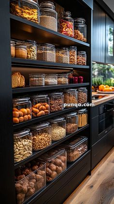 a kitchen filled with lots of food and containers on top of the shelves in front of it