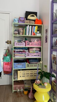 a book shelf filled with lots of books next to a white door in a room