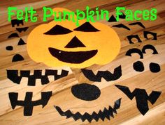 a wooden table topped with cut out pumpkin faces