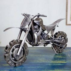 a metal model of a motorcycle on a table