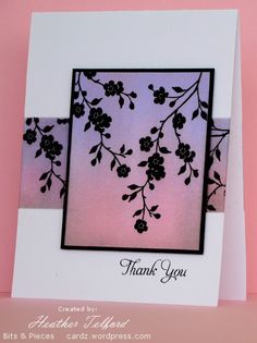 a thank you card with black flowers on pink and purple background, in front of a white envelope