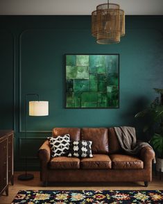 a living room with green walls and brown leather couches in front of a rug