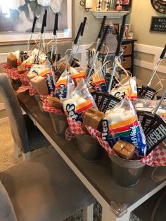 several buckets filled with snacks sitting on top of a table