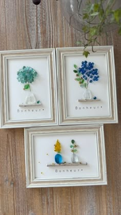 three framed pictures with vases and flowers in them