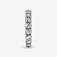 Make a classic statement with the Sparkling Row Eternity Ring. Hand-finished in sterling silver, this eternity ring features a band inlaid with sparkling clear man-made cubic zirconia. The design looks equally beautiful worn solo or stacked with other rings. Style it with bands in similar tones to create a monochromatic look, or go for contrasting metals for a combination that pops. This ring is designed to be a wardrobe essential for years to come. - Pandora Sparkling Row Eternity Ring - Sterling silver / Cubic Zirconia / Clear - Sz. 7.5 Timeless Silver Sparkling Jewelry, Timeless Sparkling Silver Jewelry, Classic Rings With Sparkling Stones For Gift, Timeless Silver Half Eternity Jewelry, Classic Rings With Sparkling Round Cut Stones, Classic Silver Rings With Sparkling Stones, Classic Sterling Silver Rings With Sparkling Stones, Classic Sterling Silver Eternity Band In Silver, Classic Sparkling Rings For Anniversary