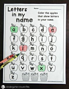 an apple themed letter formation worksheet with crayon markers on the table