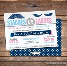 the wedding stationery is set up on a wooden table with polka dots and blue paper