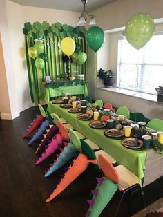 a table set up for a party with balloons