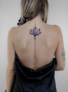 a woman with a flower tattoo on her back