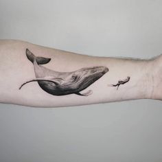 a whale tattoo on the left arm