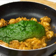 a pan filled with food and sauce on top of a stove