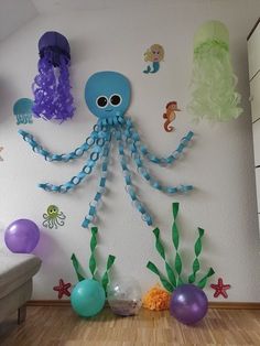 an octopus, jellyfish and other sea creatures are displayed on the wall in this child's room