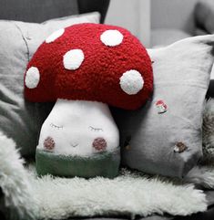 a mushroom pillow sitting on top of a couch