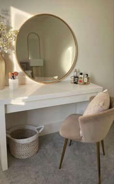 a white desk with a round mirror on it and a chair in front of it