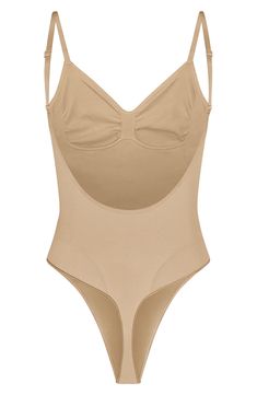 Sculpt your natural shape with a thong bodysuit that holds in your core and supports your chest flawlessly even in backless outfits. Sweetheart neck Adjustable straps 82% nylon, 18% spandex Machine wash, line dry Made in Turkey Shaping Backless Bodysuit With Built-in Bra, Stretch Backless Bodysuit With Built-in Bra, Sculpting Backless Swimwear With Built-in Bra, Shaping Backless Bodysuit Shapewear, Second-skin Bodysuit With Built-in Bra And Low Back, Shaping Shapewear With Built-in Bra And Low Back, Beige Full Coverage Bodysuit With Built-in Bra, Backless Shapewear Leotard With Built-in Bra, Seamless Stretch Low-cut Bodysuit