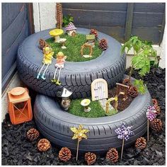 a tire planter filled with miniature garden items