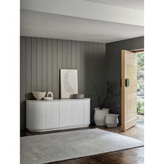 a living room with grey walls and white furniture