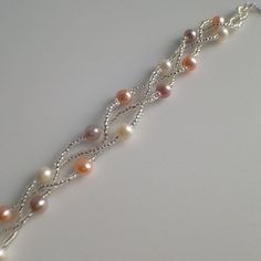 a bracelet with pearls and silver chains