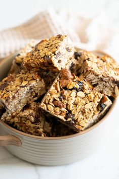 a bowl filled with granola bars on top of a table