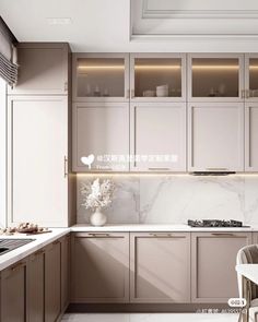 a kitchen with marble counter tops and white cabinets, along with a dining room table