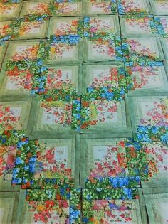 a quilted table top with flowers on it