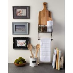 kitchen utensils and pictures hang on the wall