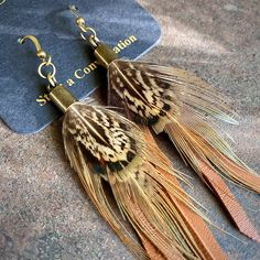 "-These tassel earrings are made from soft rust-color deerskin leather and beautiful pheasant feathers. -4\" total length, including antique-brass earwires. -Deerskin leather and pheasant feathers are sustainably sourced in the USA. -Each pair of feathers is unique. Yours may not be the exact pair seen in the photos but will look very similar to the photos. -Lightweight enough to wear every day. -Ok to get wet. -Available in 7 colors. -Designed and handmade in South Pasadena, CA. Check out more Feather Earrings Diy, Feather Ideas, Feather Fans, Earring Inspo, Diy Leather Earrings, Pheasant Feather, Wild Art, Leather Jewelry Diy, Bones Bracelet