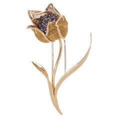 This exquisite brooch showcases a captivating floral design crafted from 18k yellow gold, featuring hinged mesh petals meticulously adorned with blue sapphires totaling an estimated weight of 1.52 carats. Originating from France circa the 1940s, this brooch boasts movable petals, adding a dynamic element to its design. While the Cartier mark may have worn off, it bears hallmarks including two eagle's heads, a maker's mark, and BTE SGEG, suggesting a possible connection to Cartier due to similarities in design hallmarks. Dimensions - Size: 6.3 x 3.2 cm (Length x width) Weight: 15.5 grams Blue Sapphires - Quantity: 19 Cut: Round faceted Carat weight: 1.52 carats in total Treatment is not indicated. Condition: Minor wear and tear, great overall condition. Slim Aarons, Eagle Head, Maker's Mark, Gold Floral, Makers Mark, Design Crafts, Cartier, Blue Sapphire, Floral Design