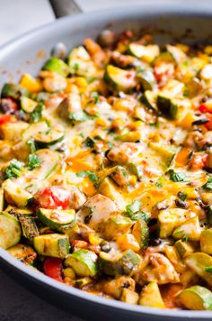 a casserole dish with zucchini, chicken and peppers in it is ready to be eaten