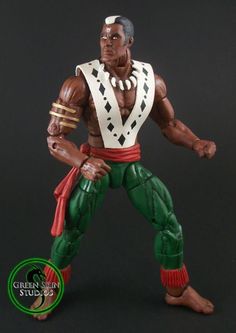 the action figure is posed in front of a black background with green and red accents