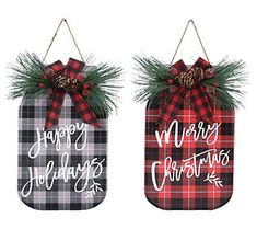 two plaid christmas decorations hanging from twine with pine cones and evergreens on top