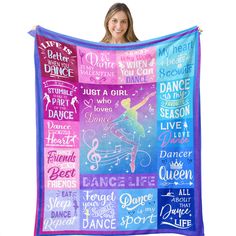 a woman is holding up a colorful blanket with words on it and an image of a dancer