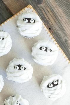 cupcakes decorated with white frosting and black eyes