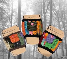 two crocheted mitts are hanging in the woods