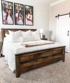 a bedroom with two pictures on the wall and a large bed in front of it