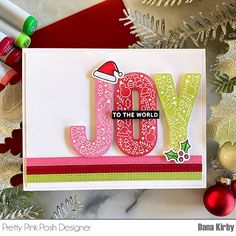 a christmas card with the word joy written on it and ornaments around it, along with other holiday decorations