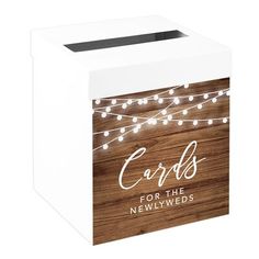 a white box with lights on it and the words cards for the newlyweds