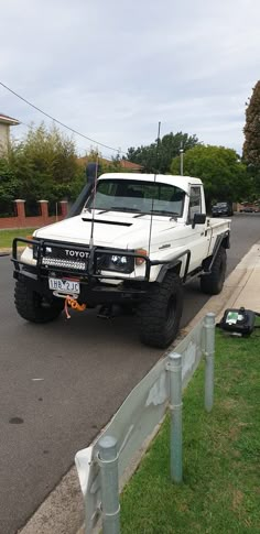 a white truck is parked on the side of the road