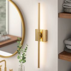 a bathroom with a mirror, sink and towel rack on the wall next to it