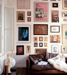 a living room filled with furniture and lots of pictures on the wall